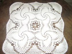 Beautiful handmade crochet windmill pattern on white tablecloth