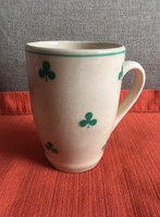 Old granite mug with green leaf motif