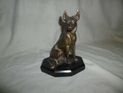 Old bronze German Shepherd dog statue on a wooden base