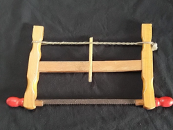 Retro toy saw - old carpenter's hand saw with a wooden frame