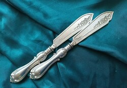 A silver-plated knife with a decorative blade