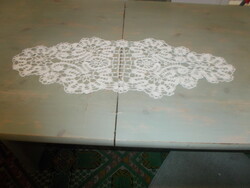 Beautiful runner with ribbon crocheted in the pattern of beaten lace