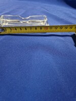 Glass toothpick holder with tooth trough.