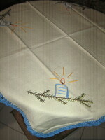 A charming hand-embroidered Christmas woven tablecloth with a crocheted edge