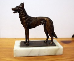 Copper Malinois dog statue on a marble plinth