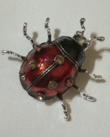 Enameled ladybug brooch.