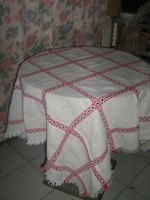 Woven black-red checkered tablecloth with a small flaw