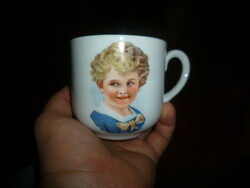Antique porcelain mug with child's head