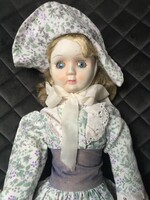 An old, vintage porcelain doll, a porcelain doll, a small doll in one - unfortunately damaged