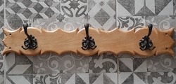 Antiqued metal hangers on a wooden base, with 3 hangers per piece