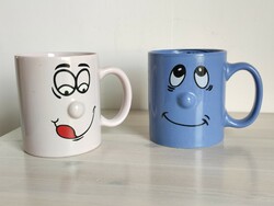 2 smiling mugs from the 90s, one with the inscription 