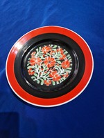 Hollóháza porcelain wall decorative plate painted red and black with a flower pattern in the middle
