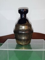 Black glass vase decorated with gold smoke