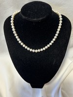 A real string of pearls with marked silver clasp, a dazzling piece