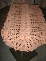 Wonderful antique handmade crochet salmon on pink needlework tablecloth