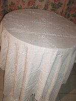 Beautiful filigree table cloth with fringed edges embroidered with white shiny white thread