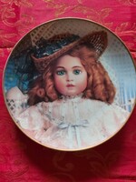 English wall porcelain decorative plate with an antique doll - in display case