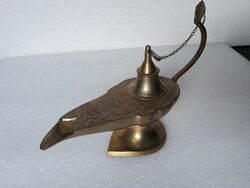 Old portable patinated copper oil lamp with candle, antique style