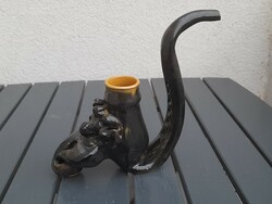 A very large glazed hard earthenware pipe with a devil's head