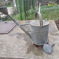 Old tin watering can with lid