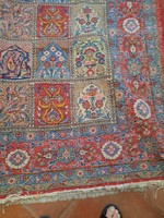 Persian rug on a red background with a blue pattern. It can be cleaned well. It is a little pale in one place