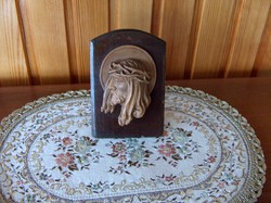 Beautiful old christ head with wooden carving standing on table
