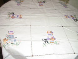 Table cloth with a charming child's pattern embroidered with a small cross stitch