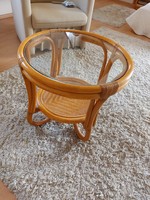 Very nice small rattan table with glass top for sale.