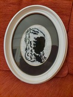 Gobelin shadow image of a woman's head in an oval frame