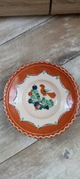 Folk ceramic wall plate with a very beautiful carved bird