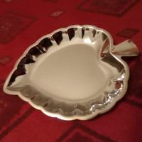 A small bowl in the shape of a silver-plated leaf