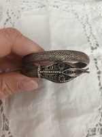 Antique Art Nouveau handcrafted silver rigid bracelet with garnet stones in the eye of a snake for sale!