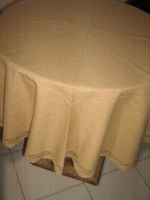Beautiful elegant beige lace-edged filigree round woven tablecloth