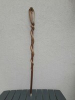 A wooden walking stick with a cobra head