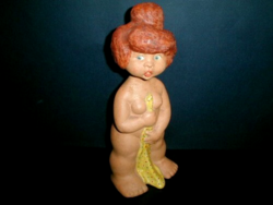 Ceramic figurine of a little girl taking a bath