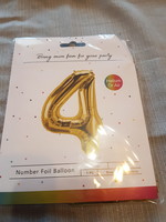 Gold colored number 4 helium balloons in unopened packaging