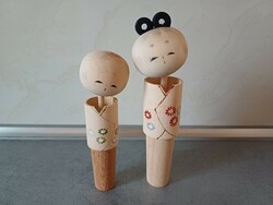A pair of collectible kokeshi wooden dolls