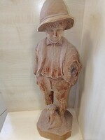 Wooden carved boy with a dog