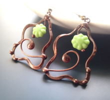 Glass beads in the shape of a green flower and earrings made of copper wire