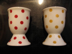 A pair of polka dot egg holders in burgundy and gold