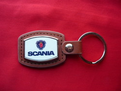 Scania metal keychain on leather background
