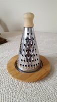 Stainless steel cheese grater on a bamboo base