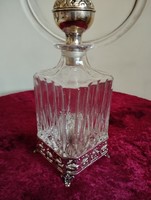 A very charming liqueur decanter on metal legs with a metal closure