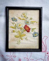 Flowers embroidered on antique canvas in a wooden frame