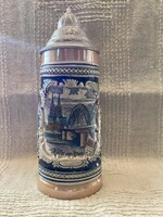 A half-liter ceramic jug with a lid depicting the skyline of Cologne
