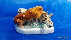 Pair of figurines of a tiger attacking a porcelain zebra