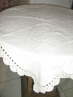 A charming hand-crocheted woven tablecloth with a lace edge