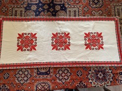 A very detailed cross-stitch tablecloth