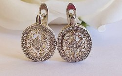 Silver earrings pierced with many stones..