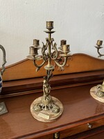 2 candle holders standing on a marble slab
